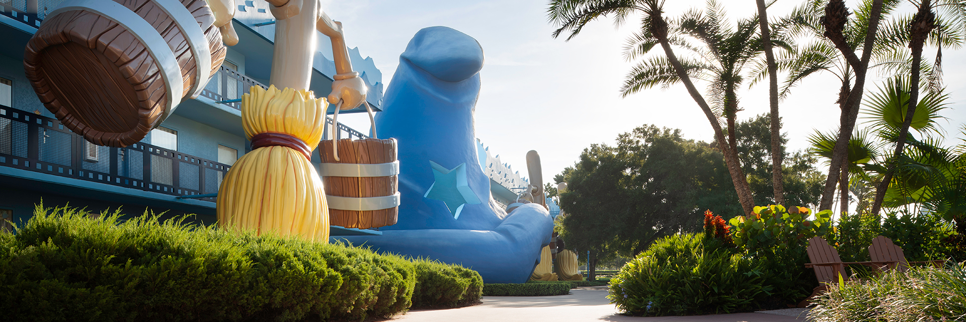 Large Sorcerer Mickey broom statue holding buckets of water outside Disney’s All-Star Movies Resort